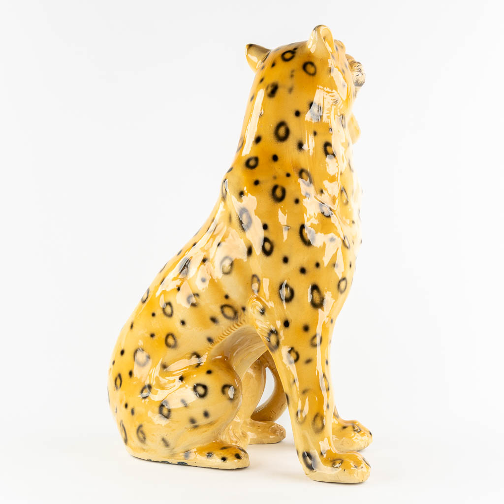 A large glazed faience Leopard, Italy, 20th C. (L:33 x W:46 x H:73 cm)