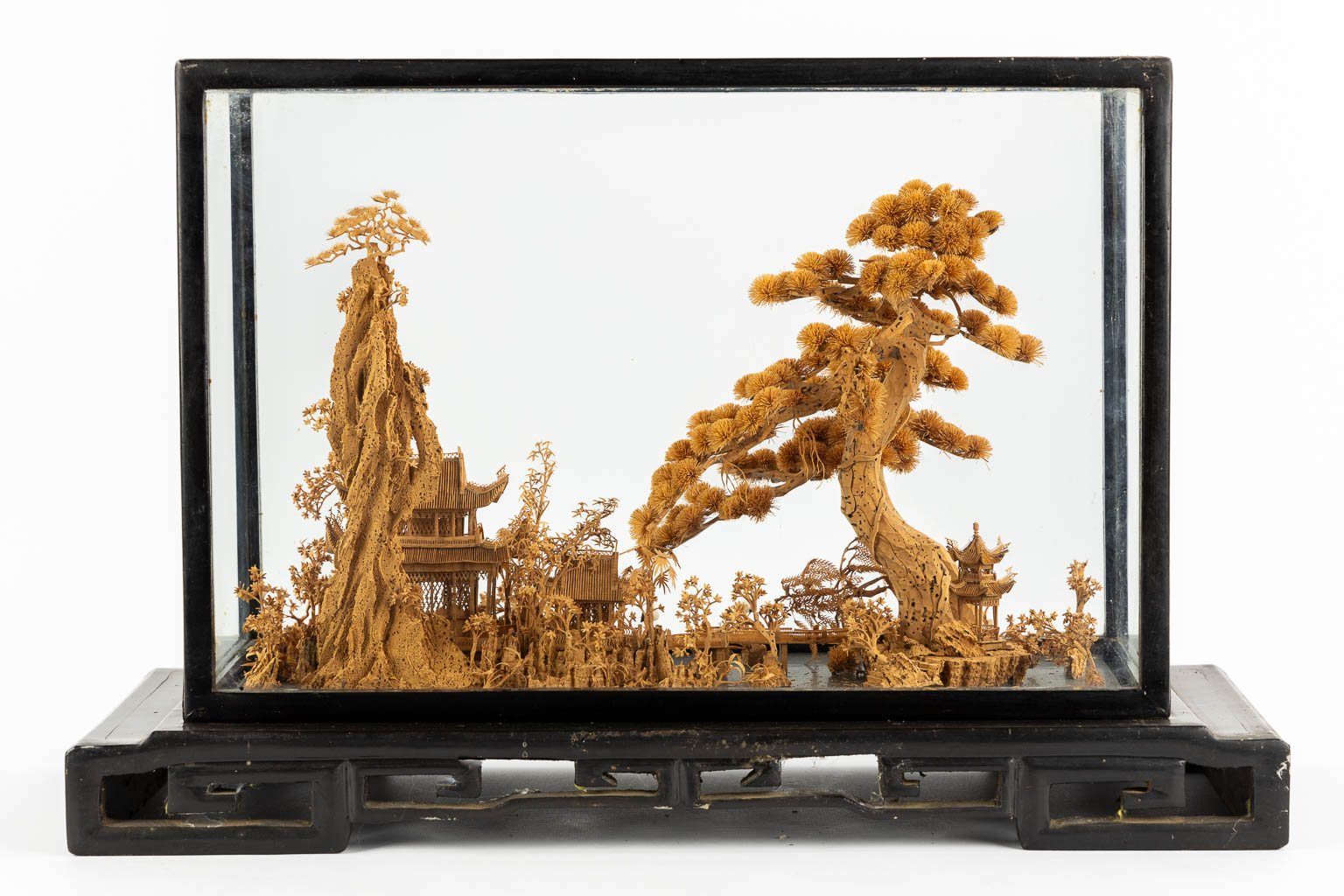 A Japanese cork diorama of a garden, in a glass display cabinet. 20th C. (L:25 x W:55 x H:36 cm)