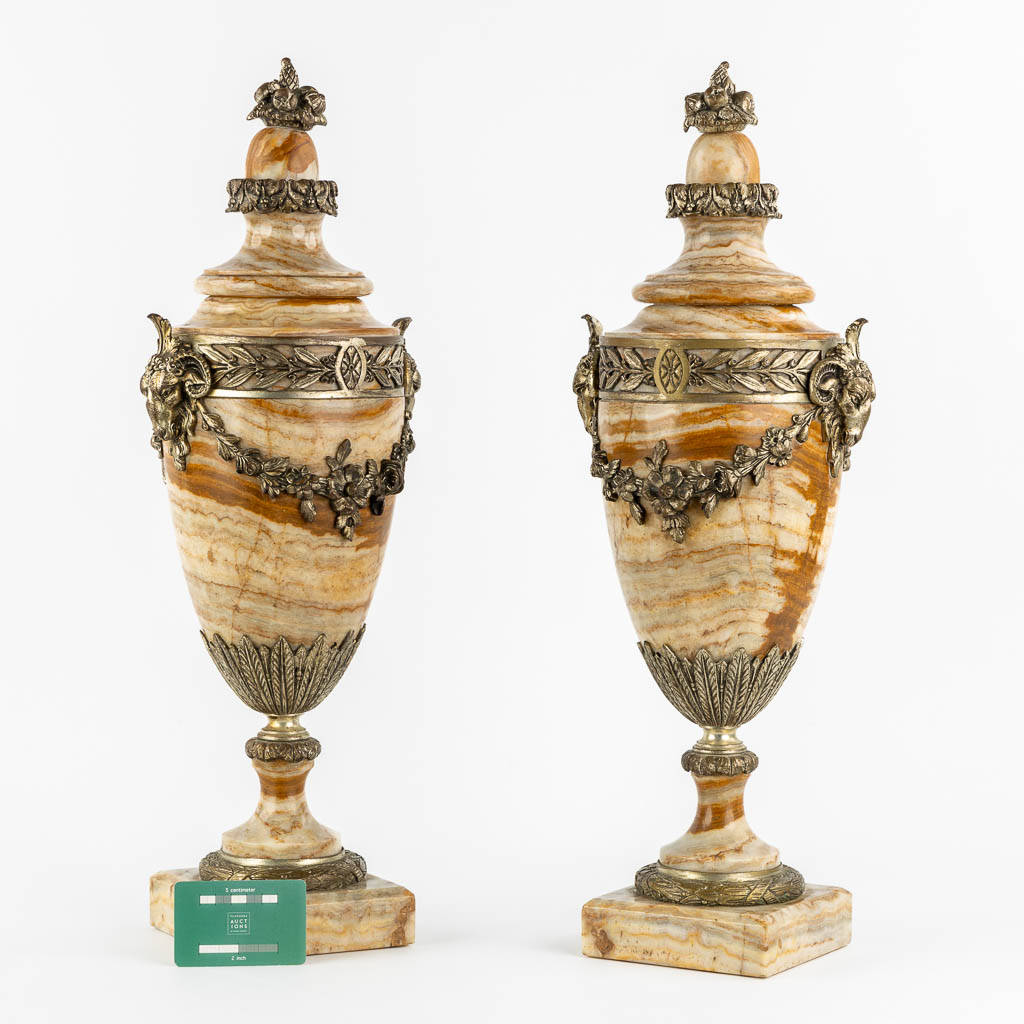 A pair of bronze mounted marble cassolettes with Ram