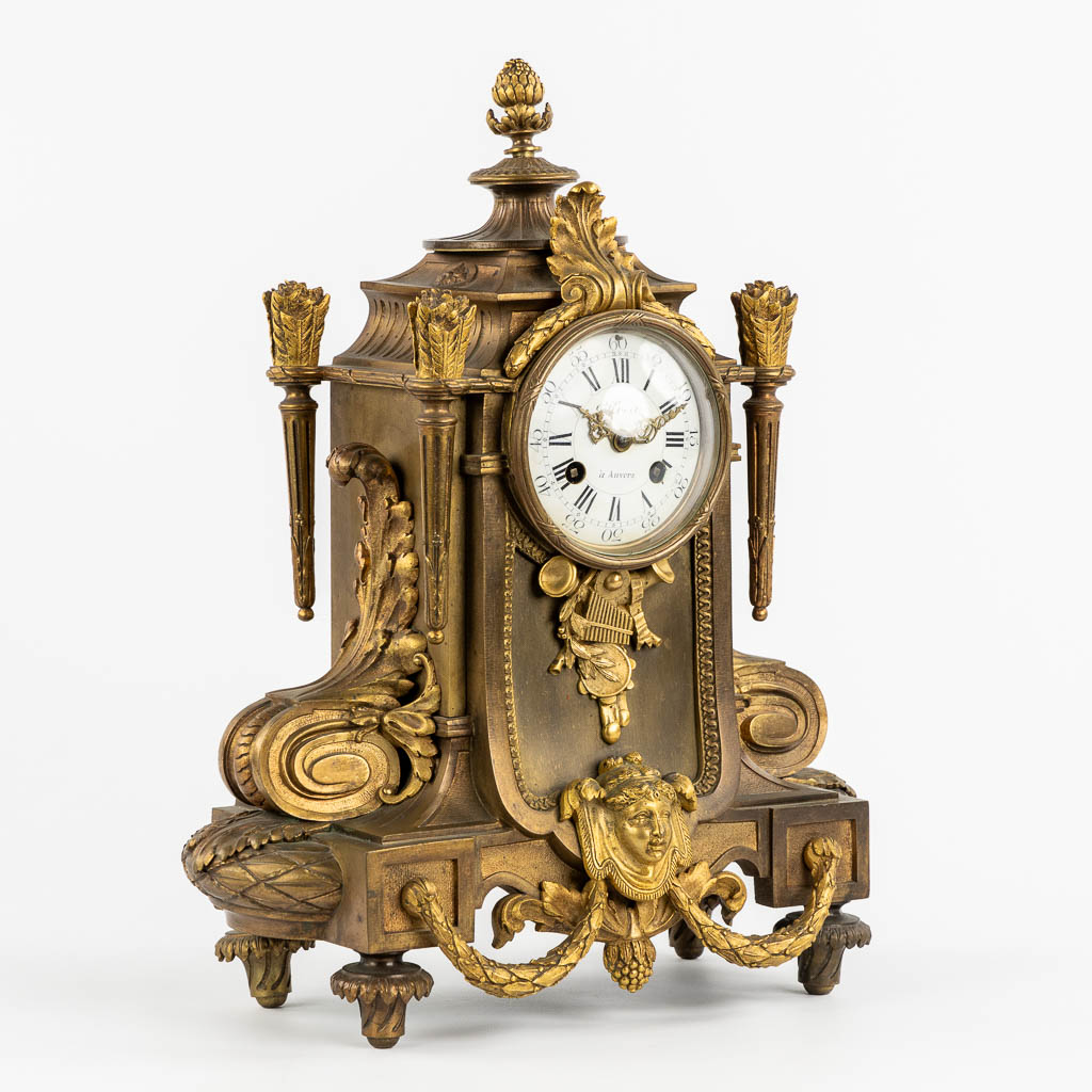 A mantle clock, gilt bronze in a Louis XVI style. Circa 1900. (L:16 x W:32 x H:41 cm)