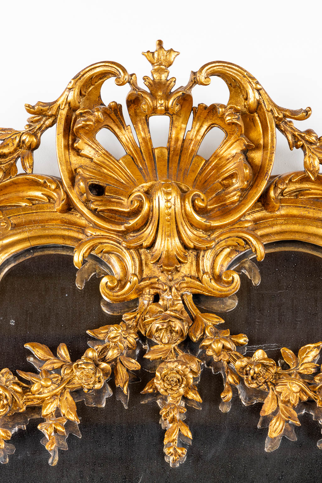 A mirror, sculptured wood, and stucco in a Louis XV style. 20th C. (W:110 x H:218 cm)