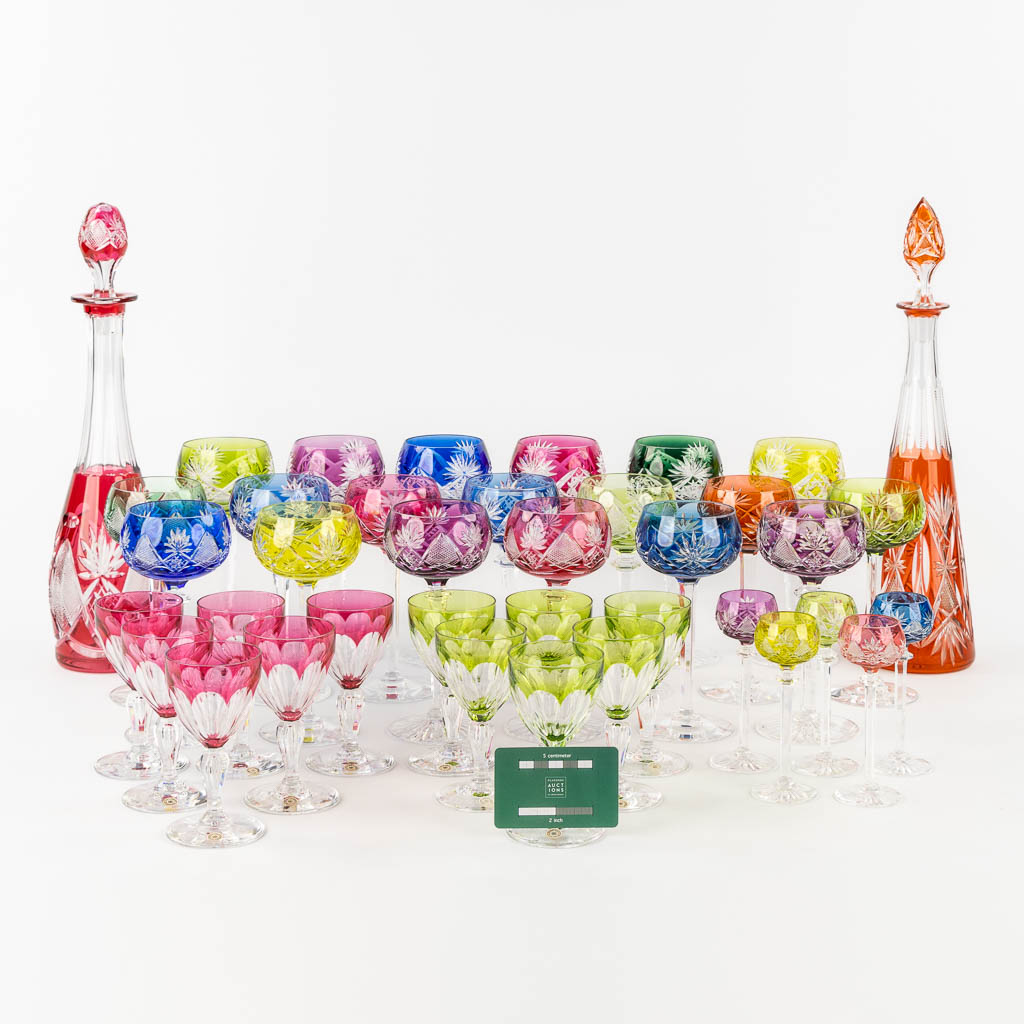 Val Saint Lambert, 36 coloured goblets and two carafes. 