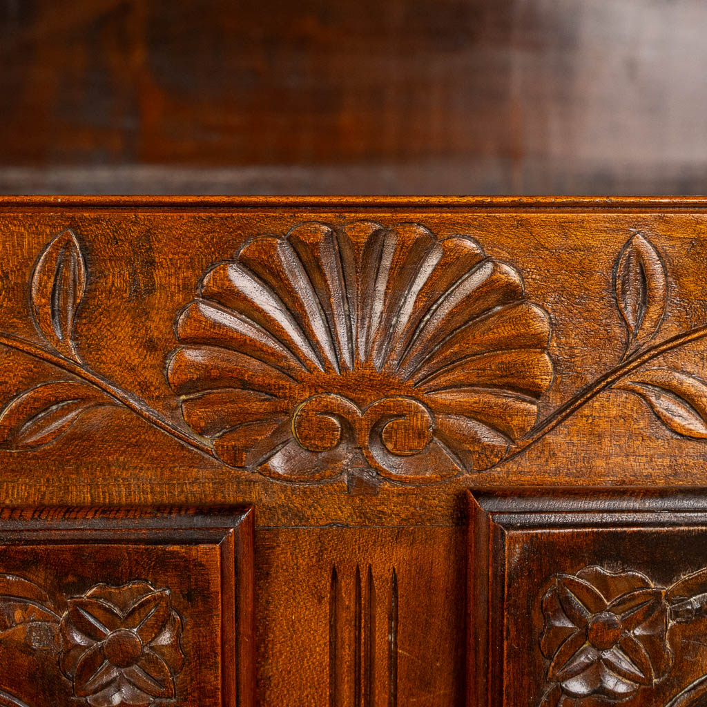 A two door-cabinet, sculptured wood finished with root-wood veneer. 