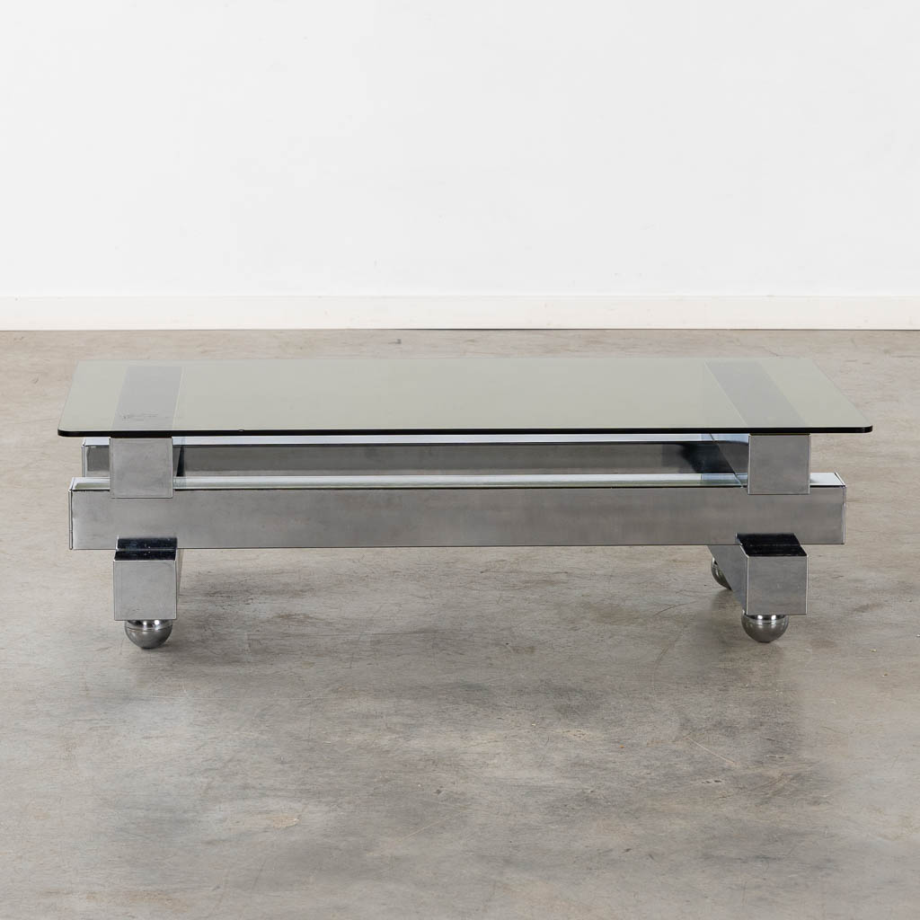 A coffee table, chromed steel and glass. (L:52 x W:104 x H:31 cm)