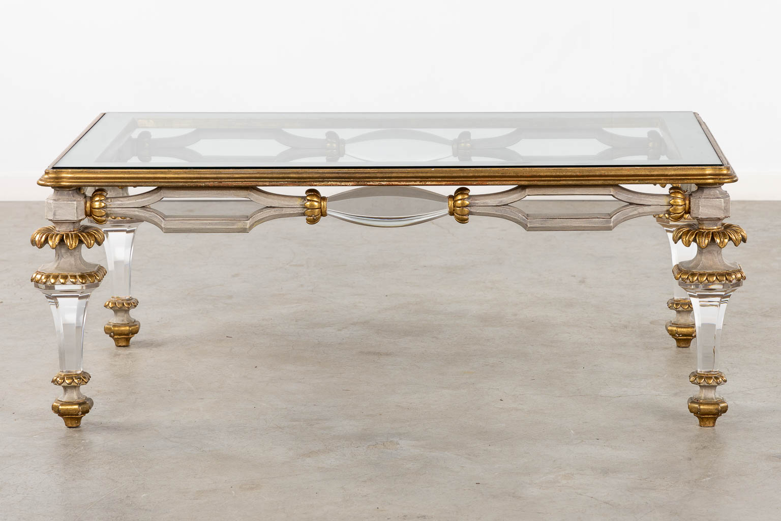 A Hollywood-Regency style coffee table, sculptured wood and plexiglass. (L:73 x W:120 x H:45 cm)