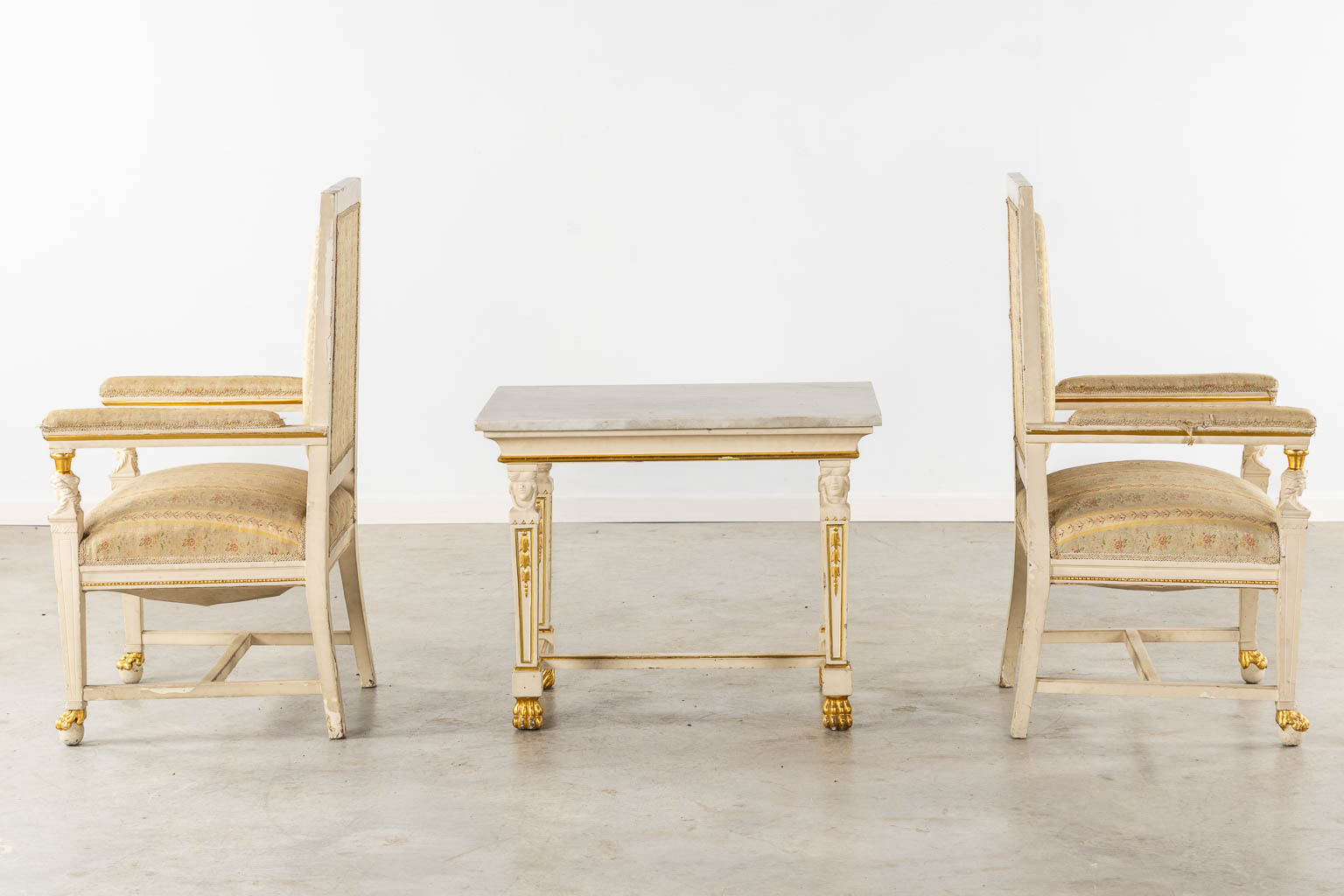 A pair of armchairs and side table, sculptured wood in Empire style. Italy, circa 1920. (L:54 x W:62 x H:105 cm)