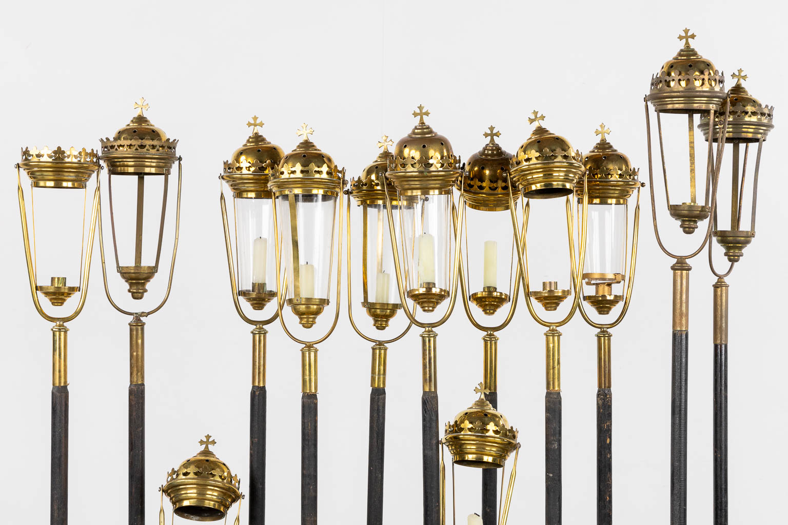 Twelve processional lanterns, brass and glass. Gothic Reivial. (H:137 cm)