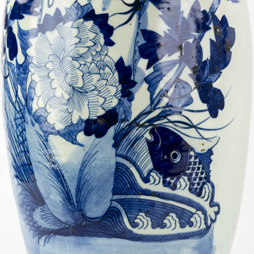 A pair of Chinese vases, blue-white decor of flowers and birds and a fish. (H:57 x D:22 cm)