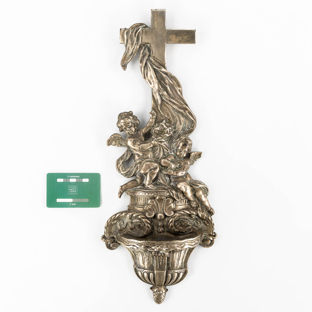 A holy water font in Baroque style, Angel figurines and a crucifix. Silver-plated bronze. 19th C.