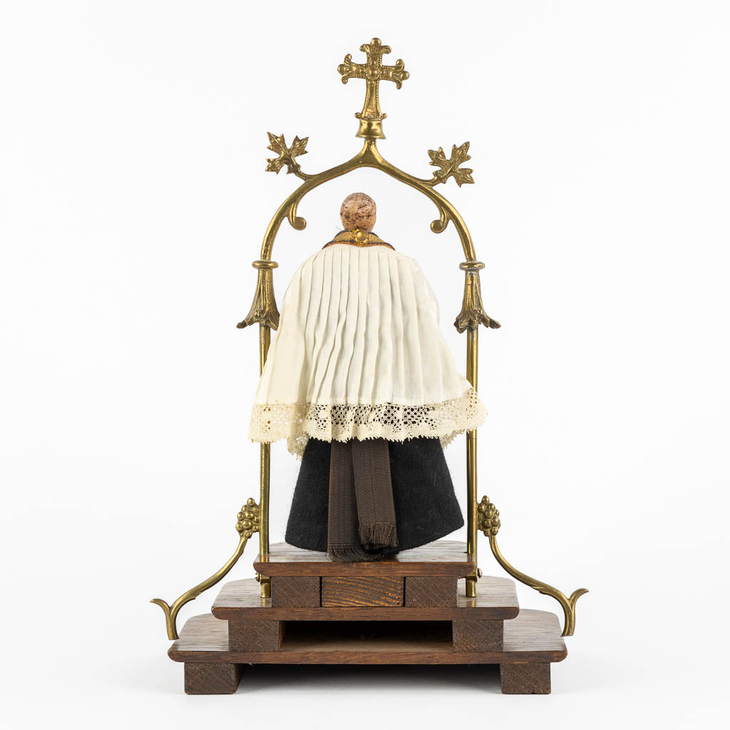 A shrine with a wax figurine of a saint, circa 1920. Gothic Revival. (L:14 x W:20 x H:33 cm)