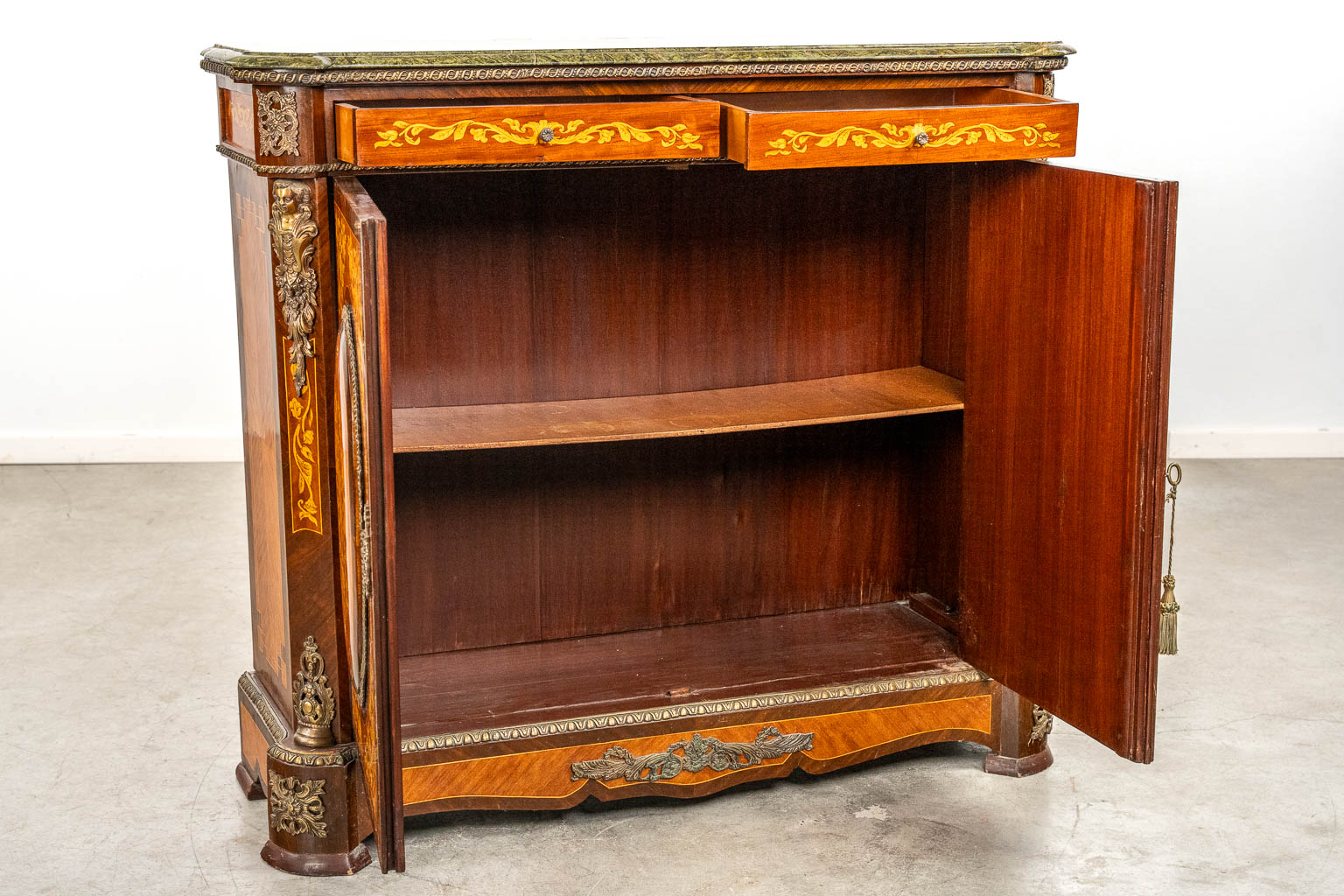 A two-door marquetry inlay cabinet, mounted with bronze and a marble. 20th C.