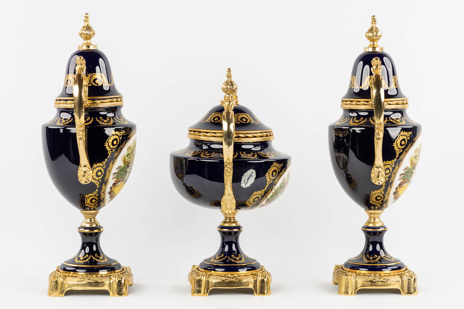 Limoges, a three-piece mantel garniture, porcelain mounted with bronze. 20th C.