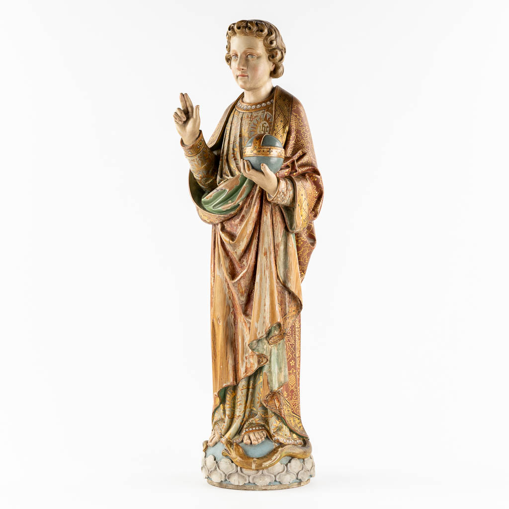 An antique wood-sculptured figurine of Salvator Mundi, holding a globus cruciger and serpent. 19th C. (L:22 x W:27 x H:87 cm)