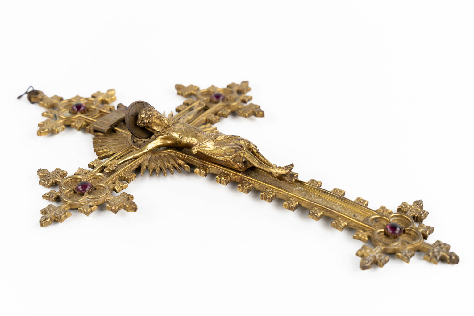 A crucifix, brass with cabochons, Gothic Revival. Circa 1900.