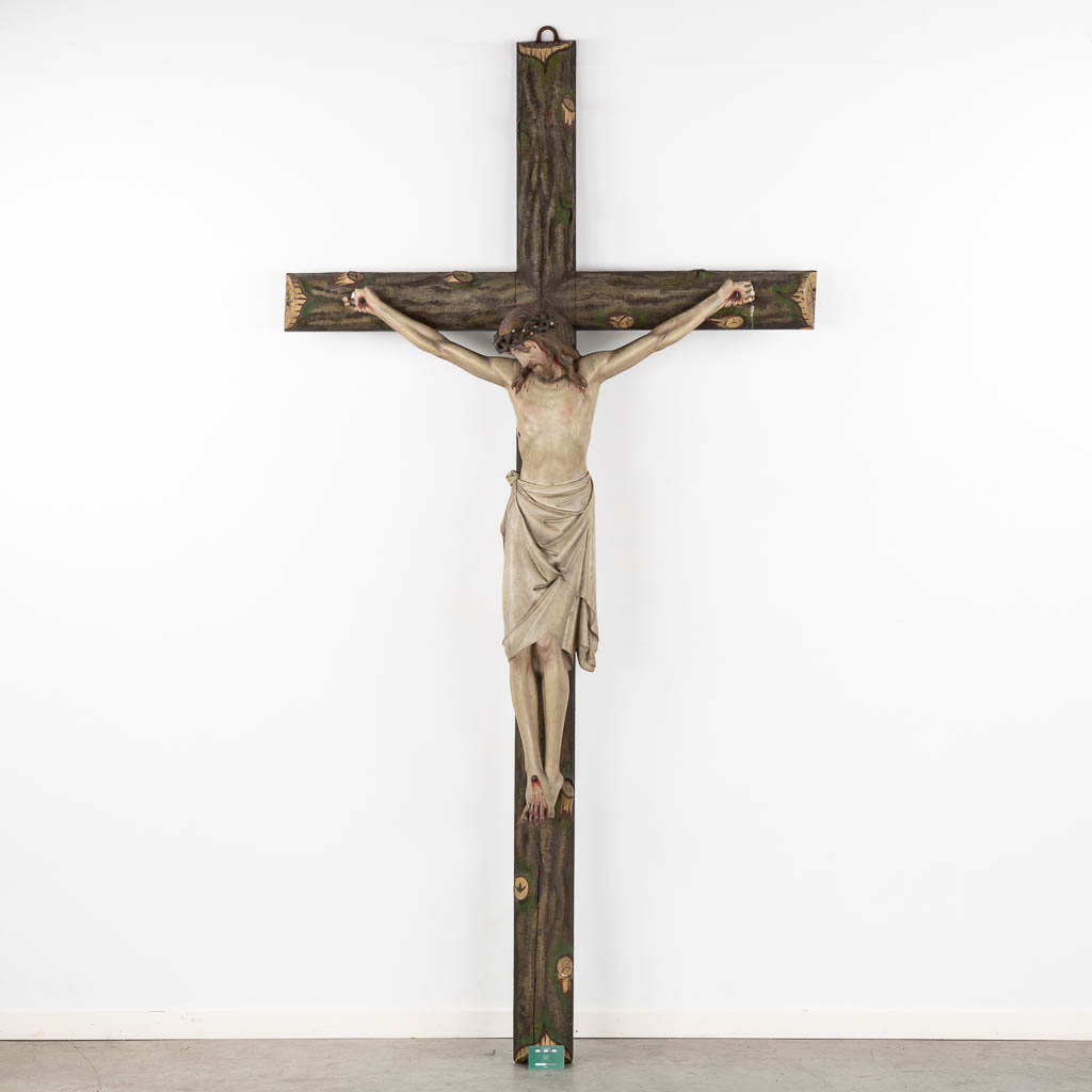 A large Corpus Christi, mounted on a faux tree crucifix, polychrome plaster. (W:130 x H:250 cm)