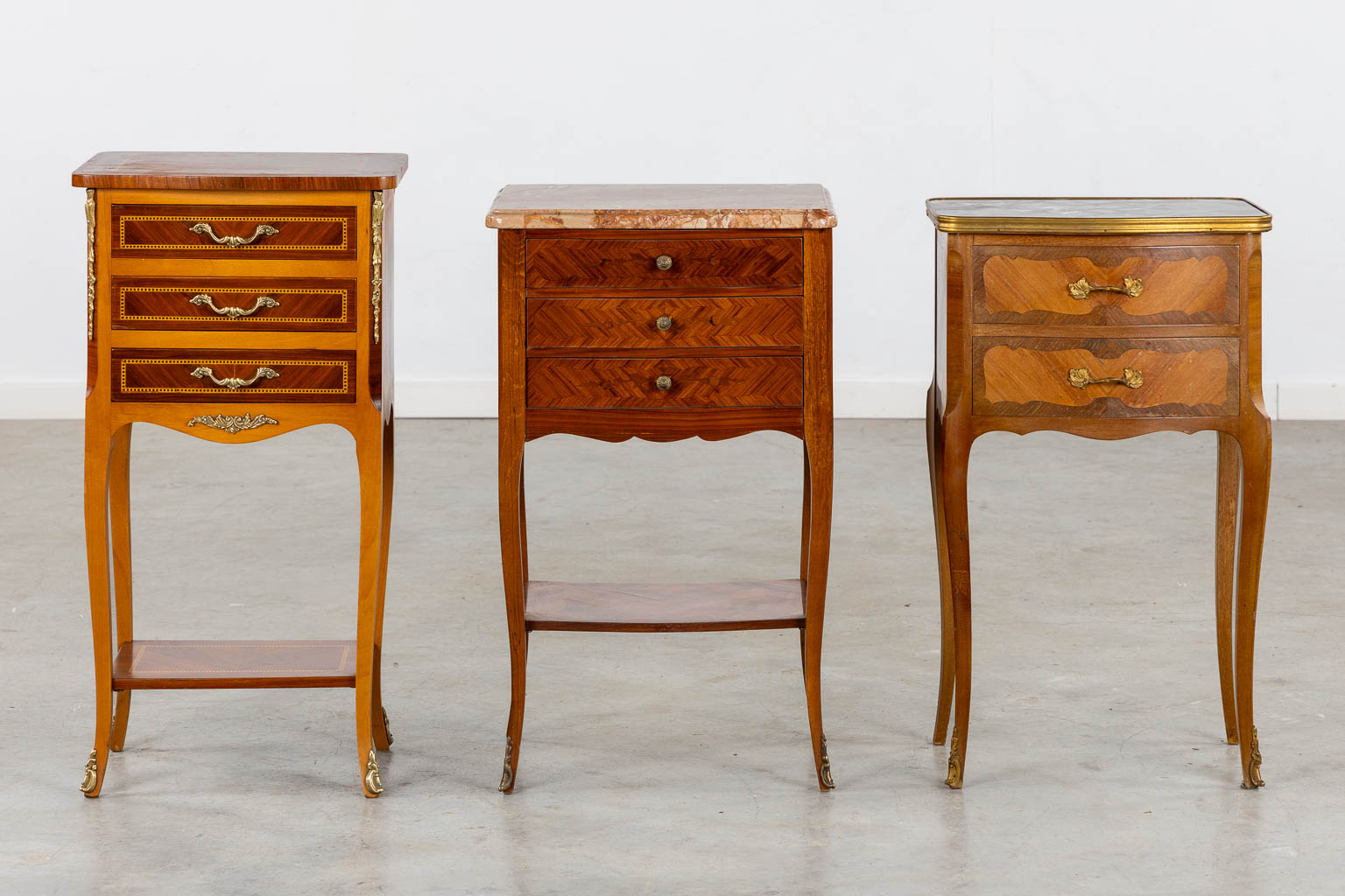 Three side tables, marquetry inlay. Two with a marble top. Circa 1980. (L:33 x W:42 x H:70 cm)