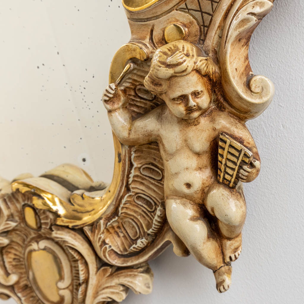 An antique mirror with musical putti. 1886. (W: 60 x H: 97 cm)