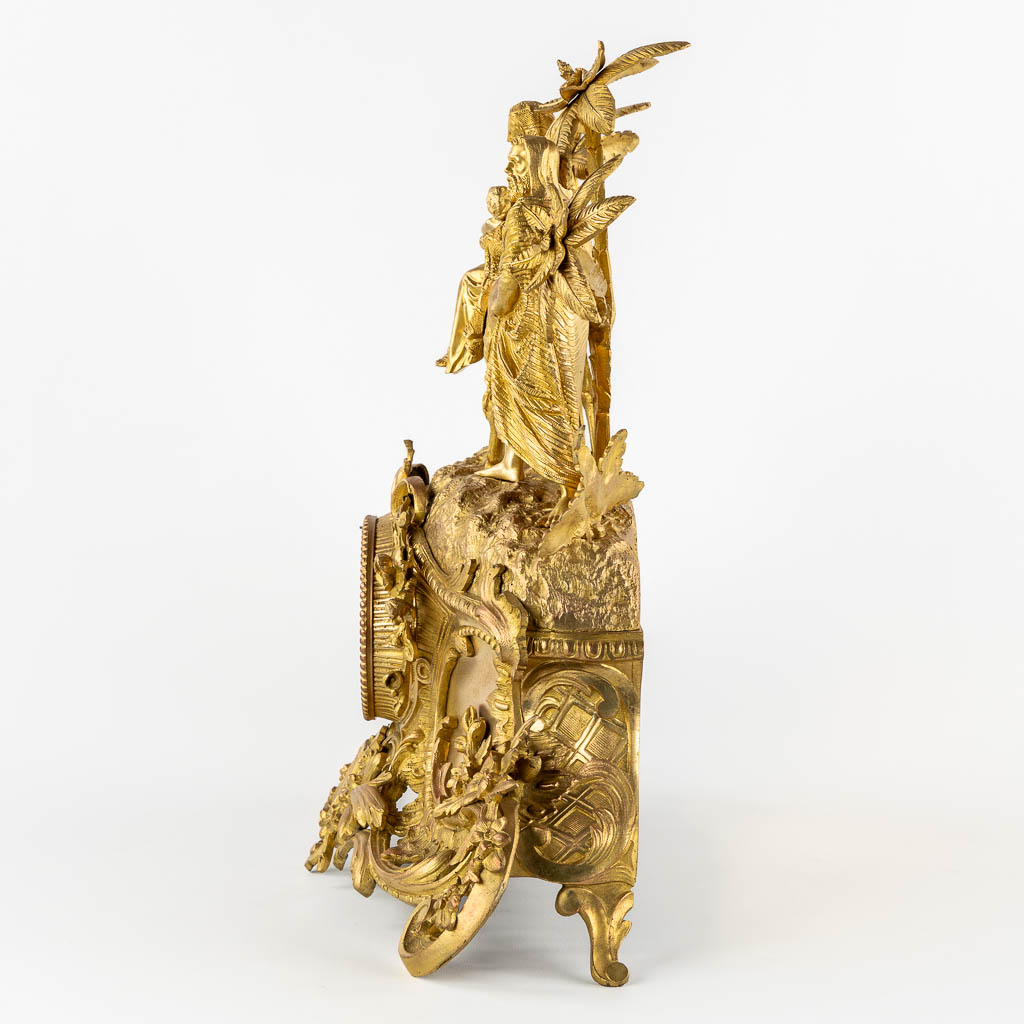 A mantle clock gilt bronze 'The Flight into Egypt'. 19th C.