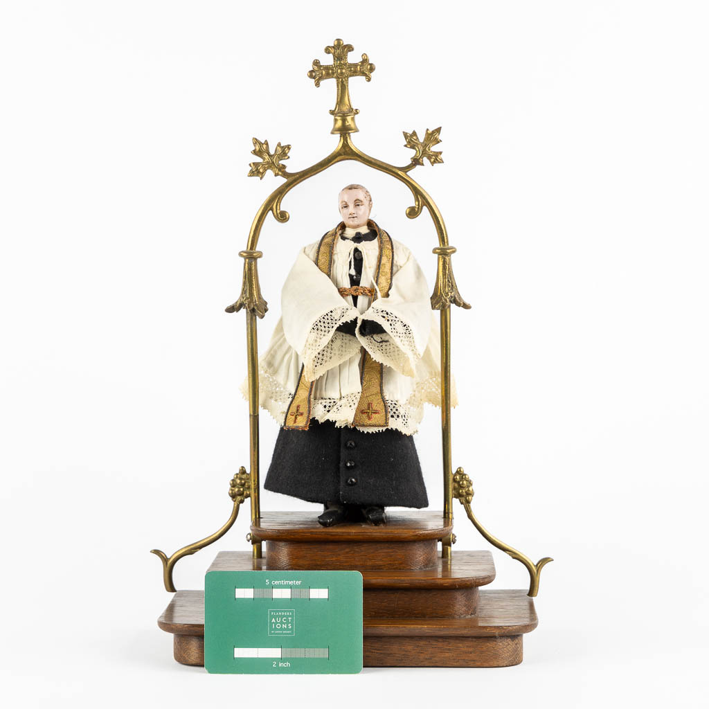 A shrine with a wax figurine of a saint, circa 1920. Gothic Revival. (L:14 x W:20 x H:33 cm)