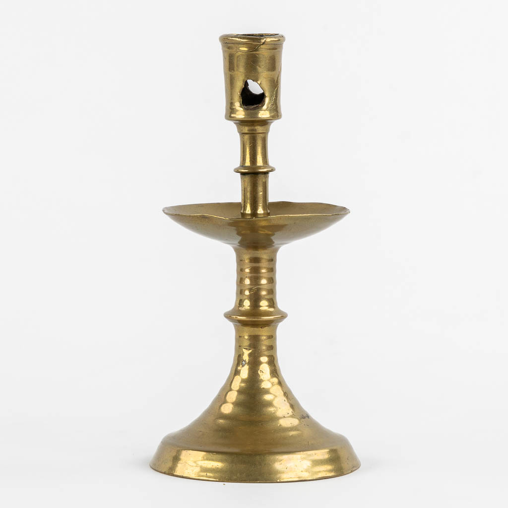 A brass disk candlestick, so-called 