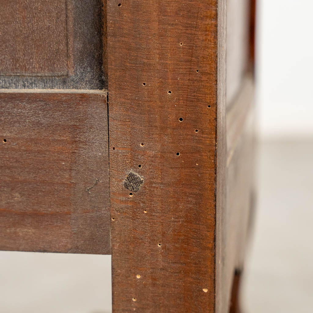 A two door-cabinet, sculptured wood finished with root-wood veneer. 