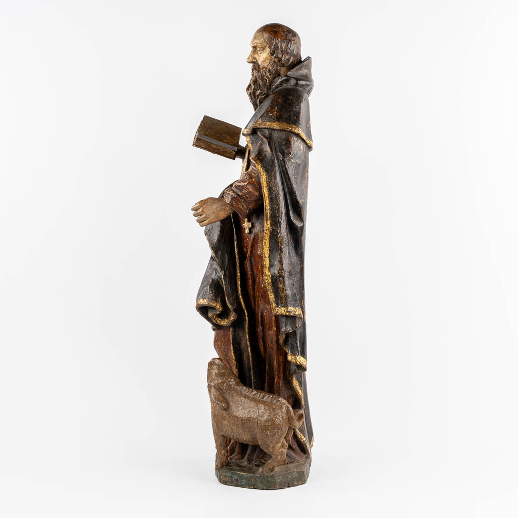 An antique wood-sculptured figurine of Saint Anthony the Great, with a pig. 18th C.