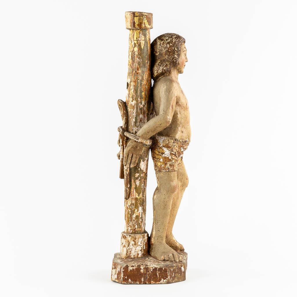 An antique wood-sculpture 'Saint Sebastian', patinated and gilt. 17th/18th C.