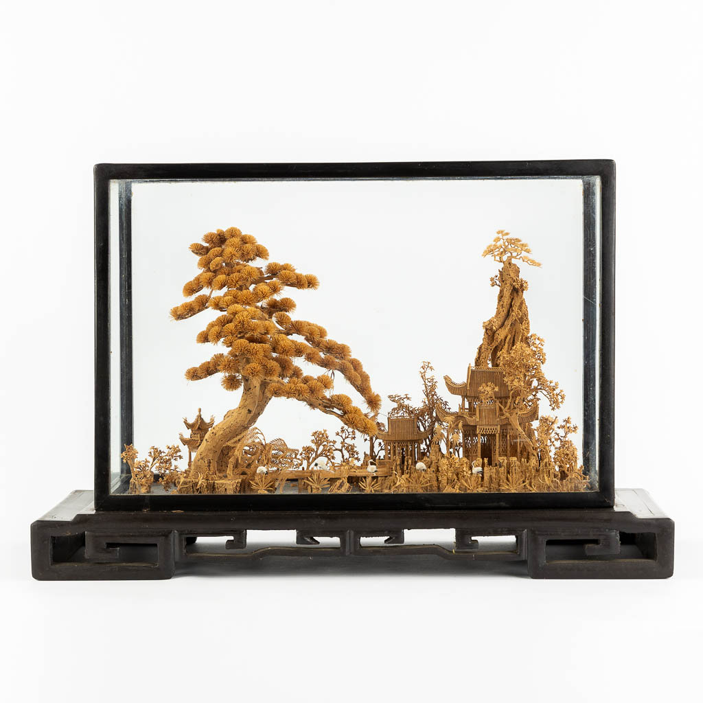 A Japanese cork diorama of a garden, in a glass display cabinet. 20th C. (L:25 x W:55 x H:36 cm)