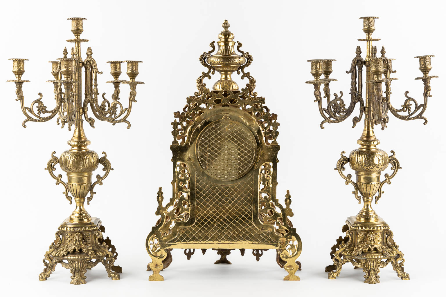 A large three-piece mantle garniture clock, polished bronze. Circa 1970.