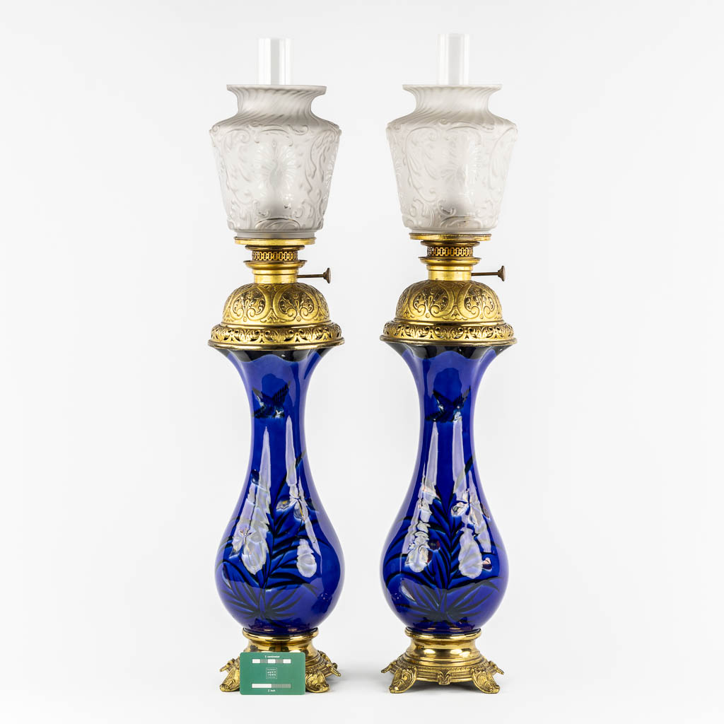 A pair of large oil lamps, porcelain and brass. Circa 1900. 