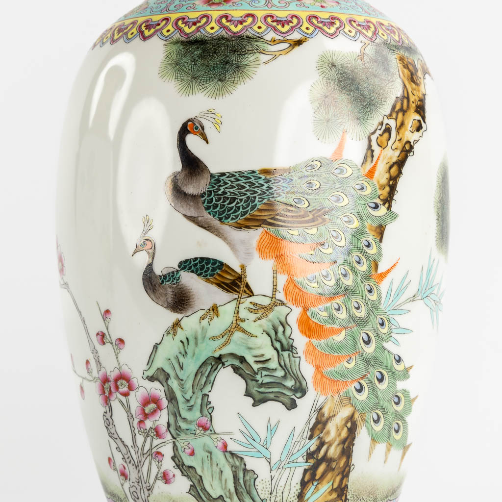 Two Chinese vases with a double peacock and floral decor. (H:45 x D:19 cm)