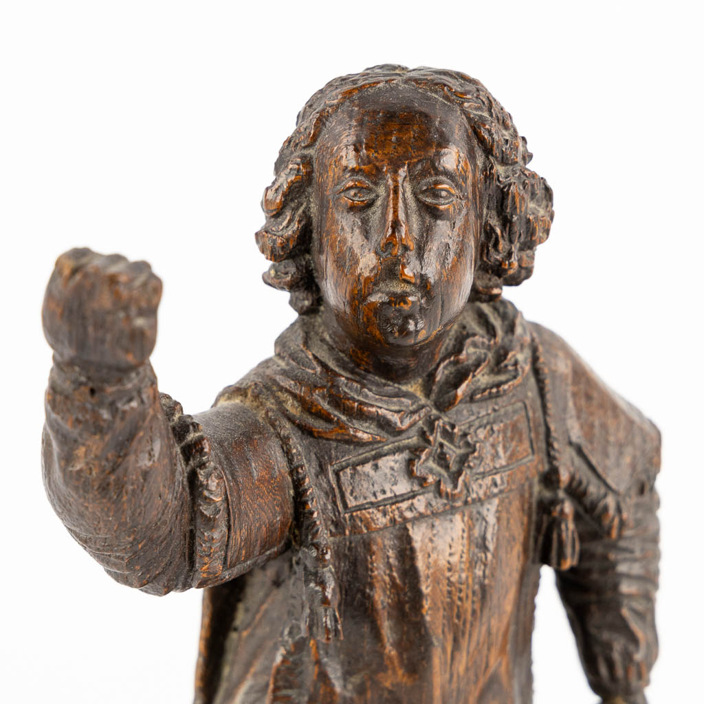 An antique wood-sculptured figurine of a saint holding a scourge. 17th C. (W:10 x H:29 cm)