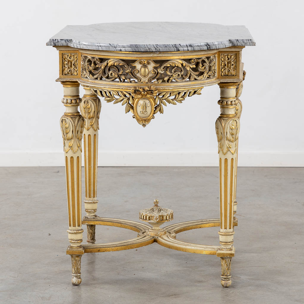 A wood-sculptured and patinated table with a grey marble, Louis XVI style. (L:65 x W:112 x H:80 cm)