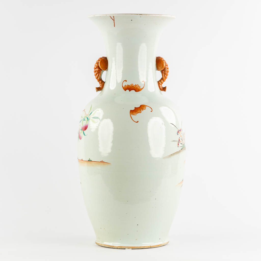 A large Chinese Famille Rose vase with a peach decor and elephant handles. 19th C. (H:70 x D:34 cm)