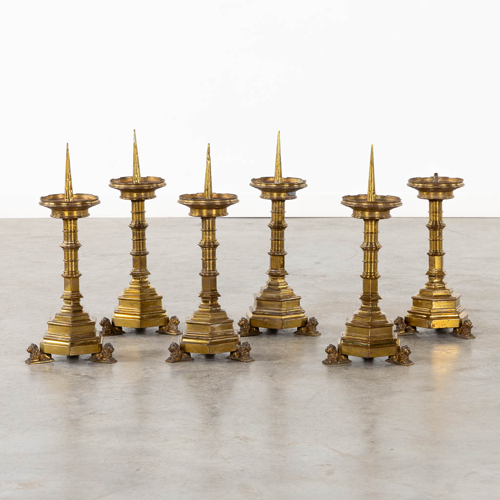 A set of six candlesticks, bronze standing on lions, Gothic Revival style. (L:17 x W:17 x H:45 cm)