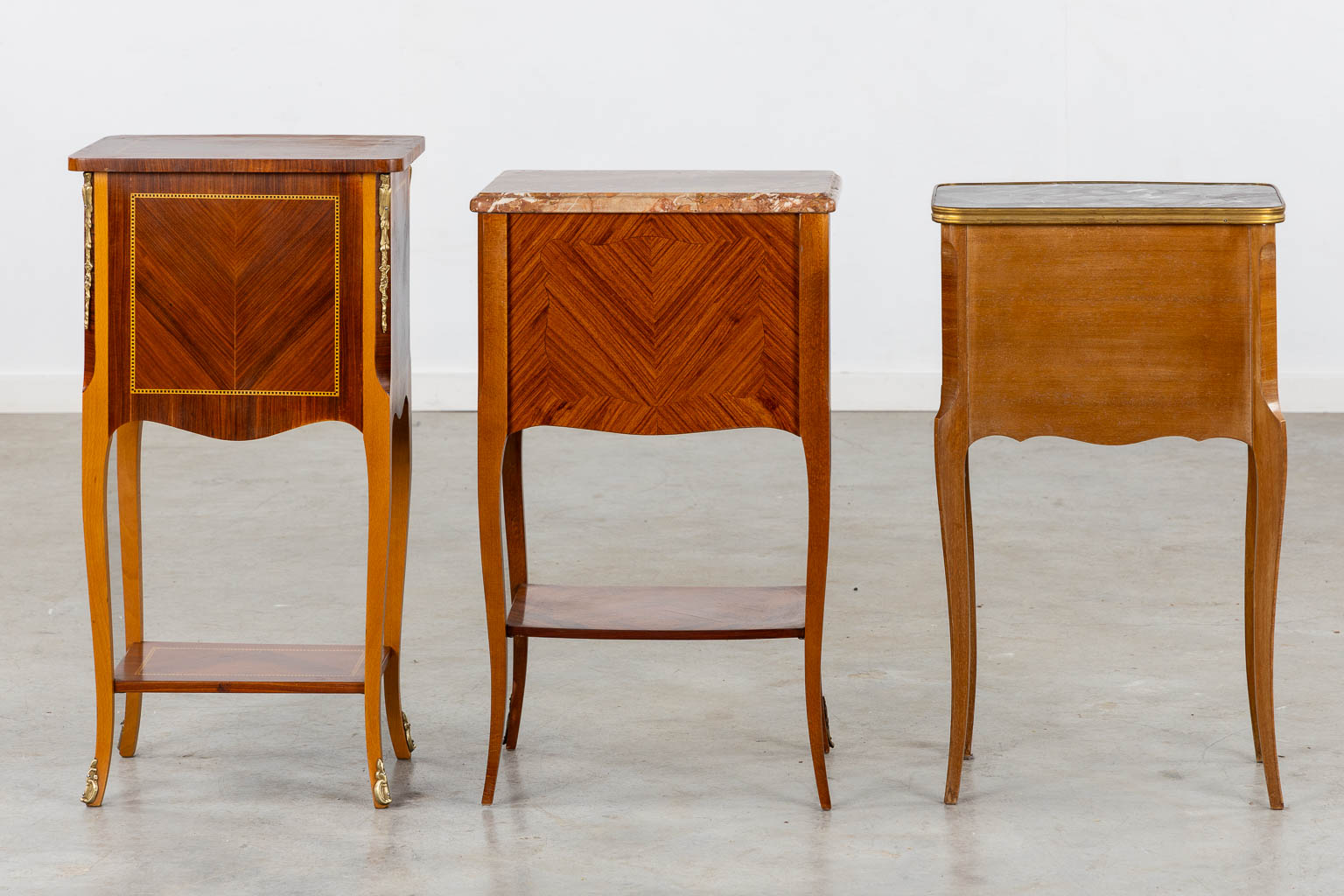 Three side tables, marquetry inlay. Two with a marble top. Circa 1980. (L:33 x W:42 x H:70 cm)