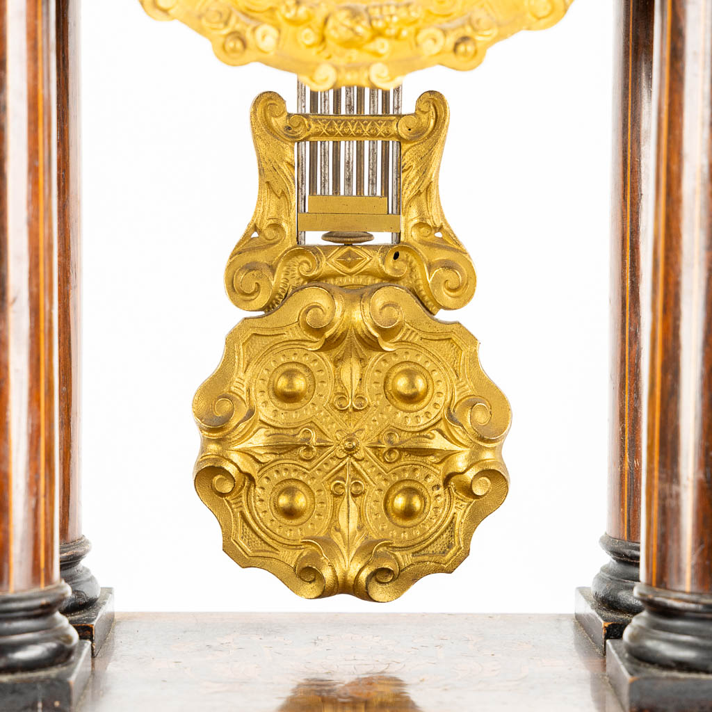 A column clock, marquetry inlay and gilt bronze. 19th C. (L:15 x W:25 x H:46 cm)