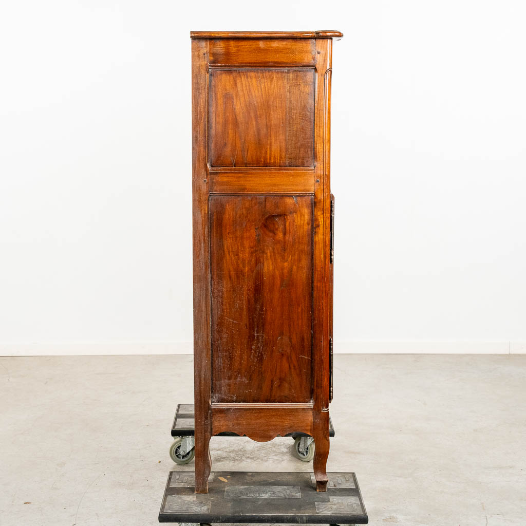 A two door-cabinet, sculptured wood finished with root-wood veneer. 