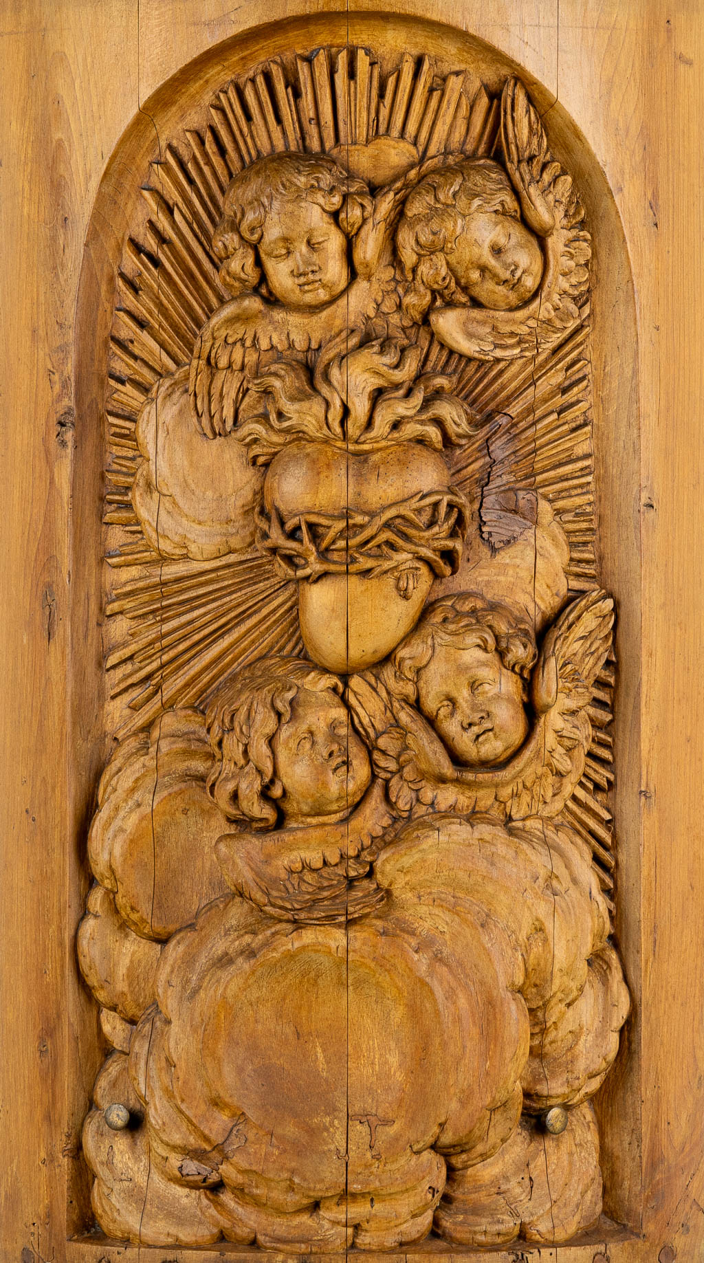 A wood-sculptured tabernacle door, Angels and a Sacred Heart, Baroque style. 