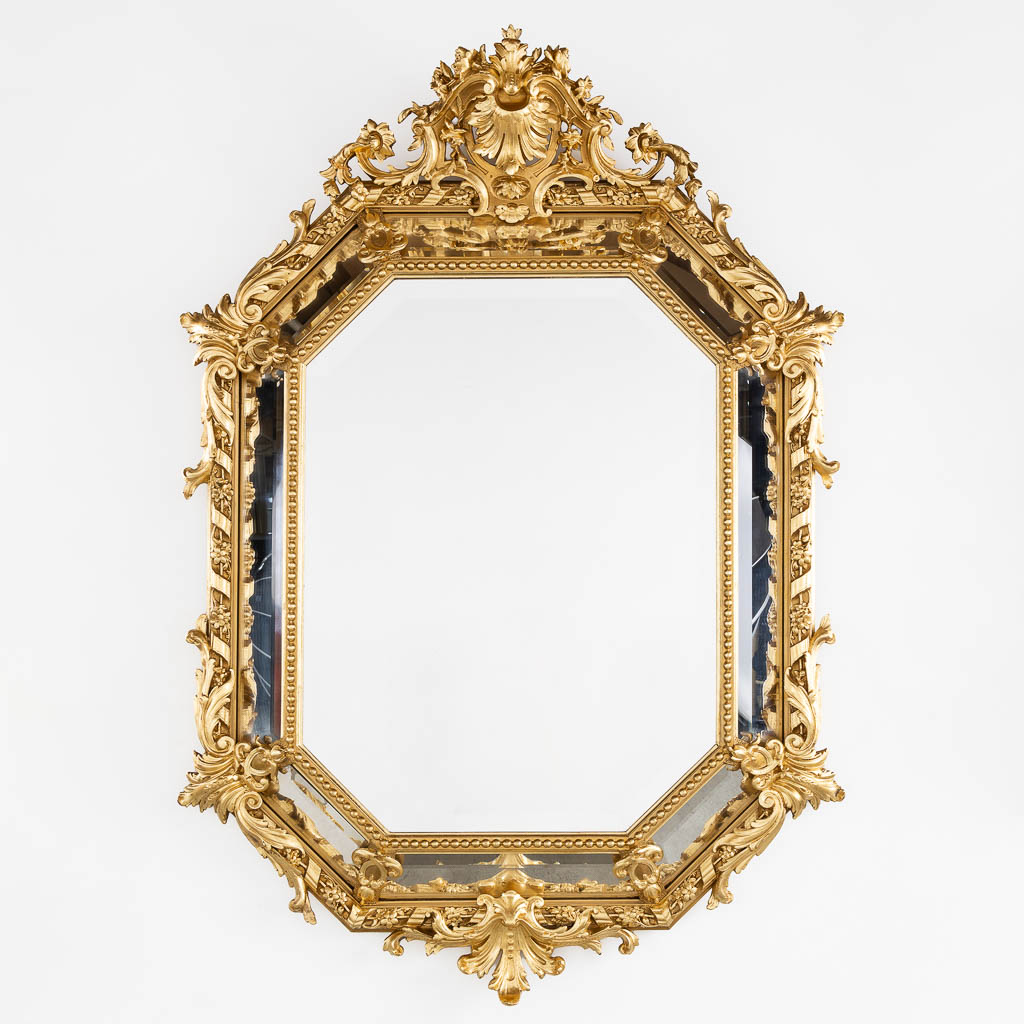 An antique mirror, sculptured gilt stucco and facetted glass, Louis XV style. 19th C. (W:98 x H:140 cm)