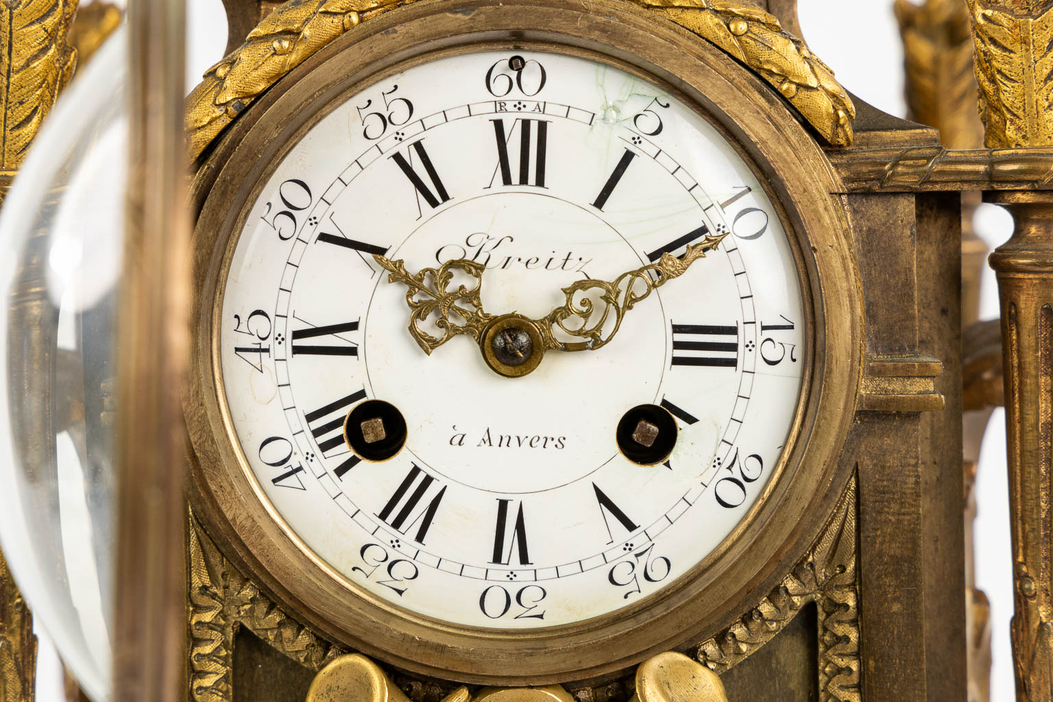 A mantle clock, gilt bronze in a Louis XVI style. Circa 1900. (L:16 x W:32 x H:41 cm)