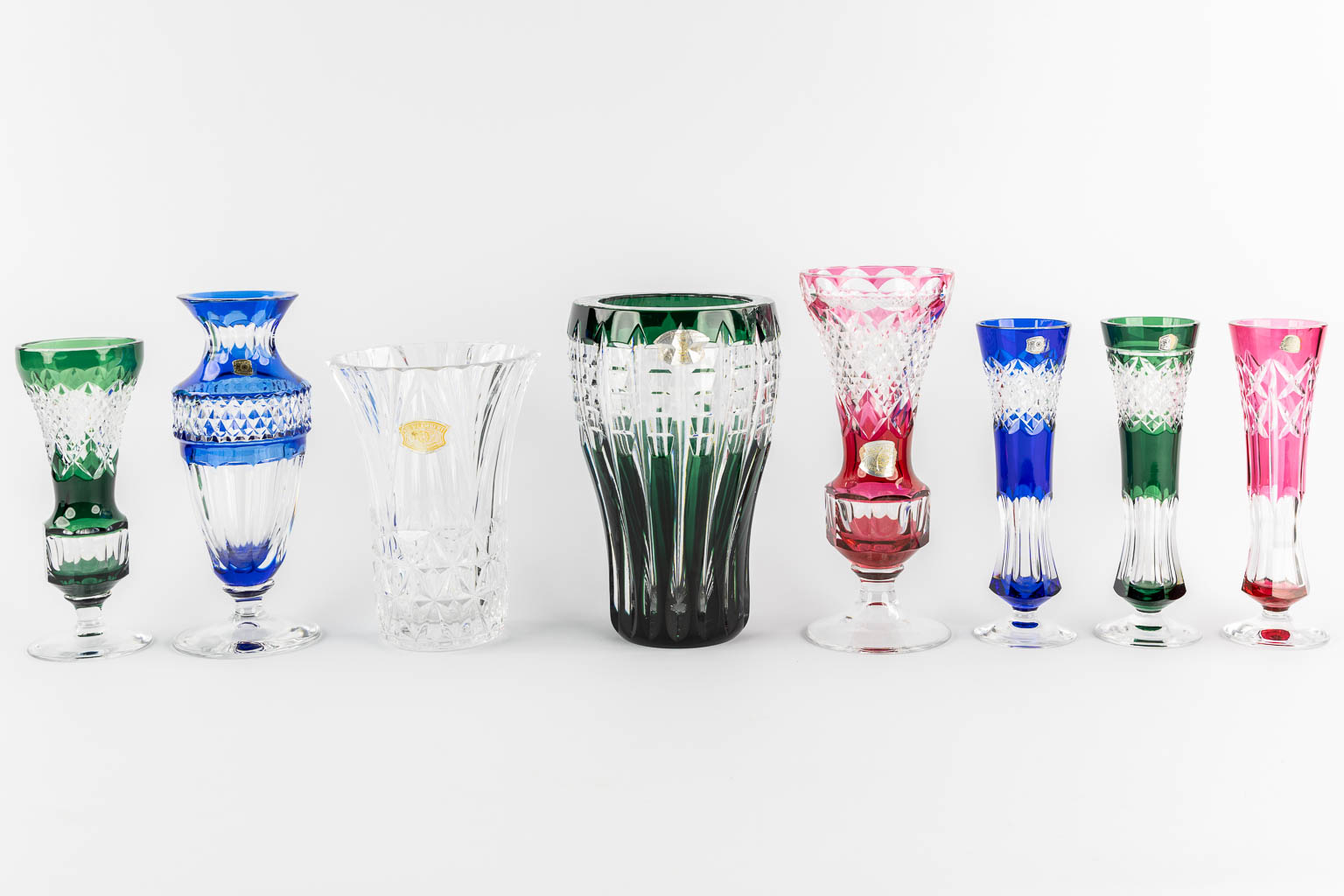 Val Saint Lambert, eight cut and coloured crystal vases. 