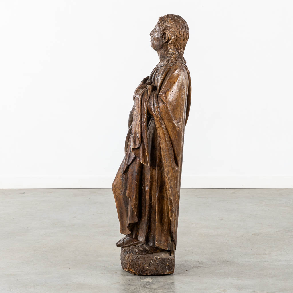 Flemish school, a wood-sculptured figurine of Saint John. 15th C. (L:26 x W:37 x H:105 cm)