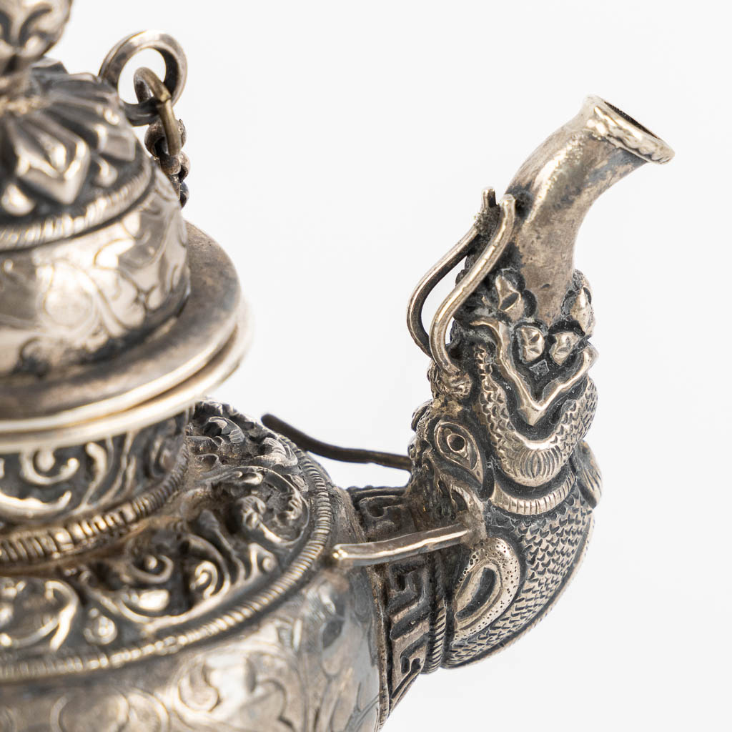 A small silver and Ceremonial teapot, Probably Tibet. (L:7 x W:12 x H:11,5 cm)