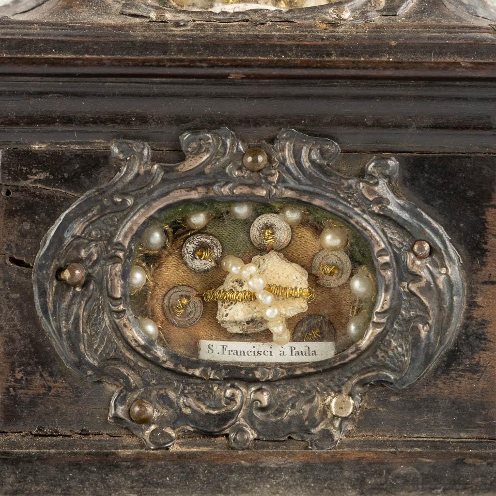 An ebonised wood Reliquary crucifix, 7 relics, mounted with silver. 19th C. (W:17 x H:50 cm)