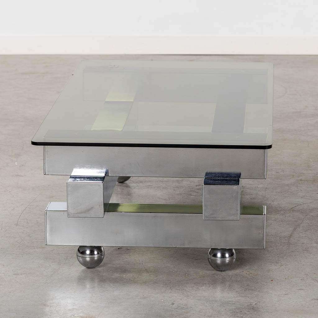 A coffee table, chromed steel and glass. (L:52 x W:104 x H:31 cm)