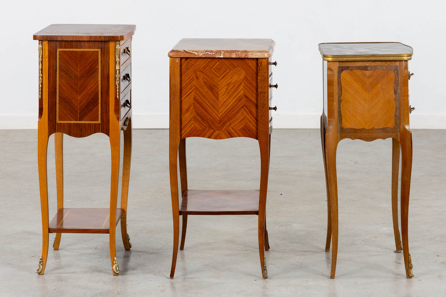 Three side tables, marquetry inlay. Two with a marble top. Circa 1980. (L:33 x W:42 x H:70 cm)