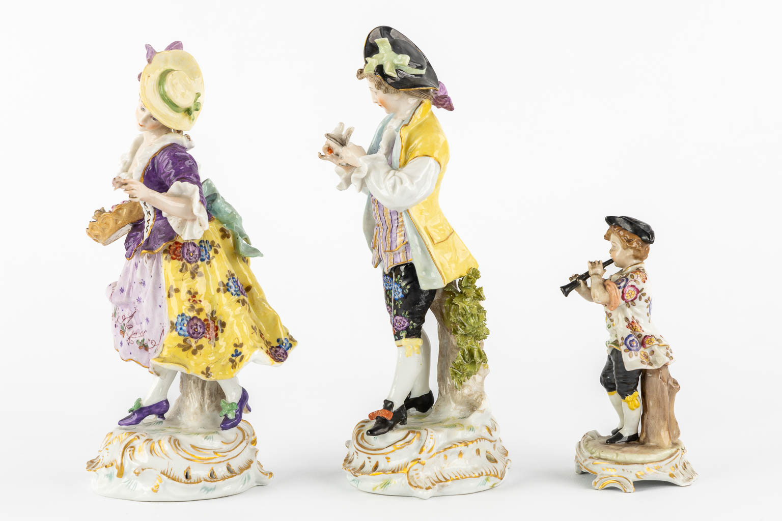 A pair of polychrome porcelain figurines, added A Saxony porcelain boy. (H:23,5 cm)