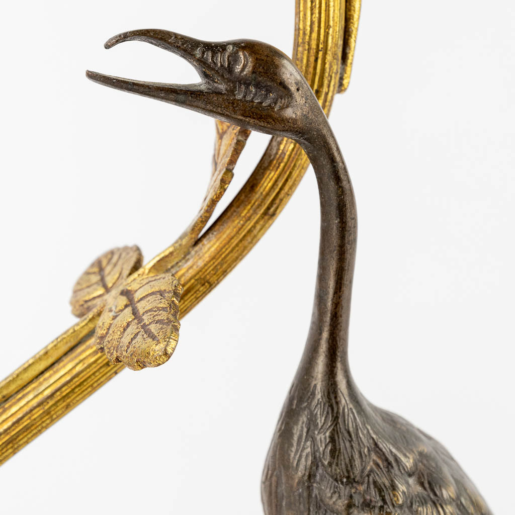 A table lamp with a large bird, probably a Heron. Patinated and gilt bronze, circa 1900. (W:33 x H:37 cm)