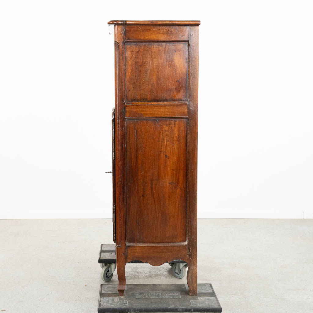 A two door-cabinet, sculptured wood finished with root-wood veneer. 